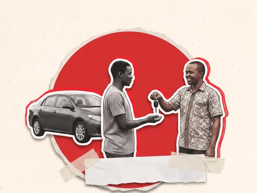 A seller handing car keys to a buyer